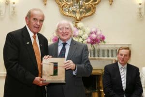 Colm McLoughlin accepting the Irish Presidential Distinguised Service Award from the Irish President, Michael D Higgins while An Taoiseach Enda Kenny looks on